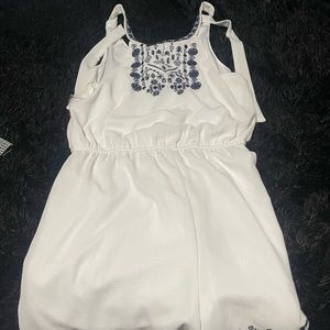 Never worn white romper with blue detailing. Size large.